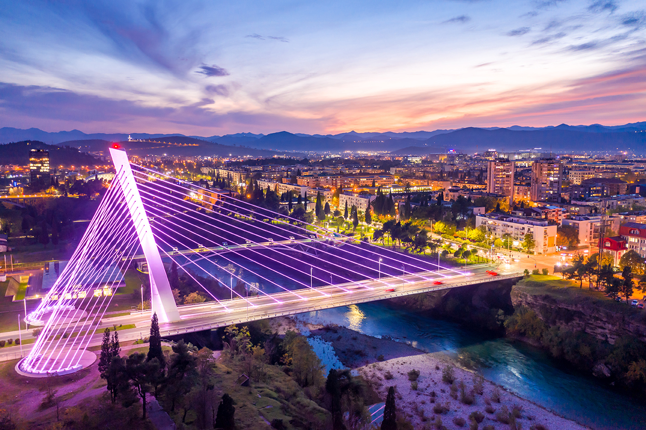 Podgorica, Montenegro, at night, featuring illuminated Millenniu Podgorica, Montenegro, at night, featuring illuminated Millennium Bridge